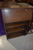 An early 20th Century oak bureau of small proportions with open bookshelf under, width approx. 69cm