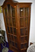 An early to mid 20th Century oak display cabinet, having glazed centre and side panels, single