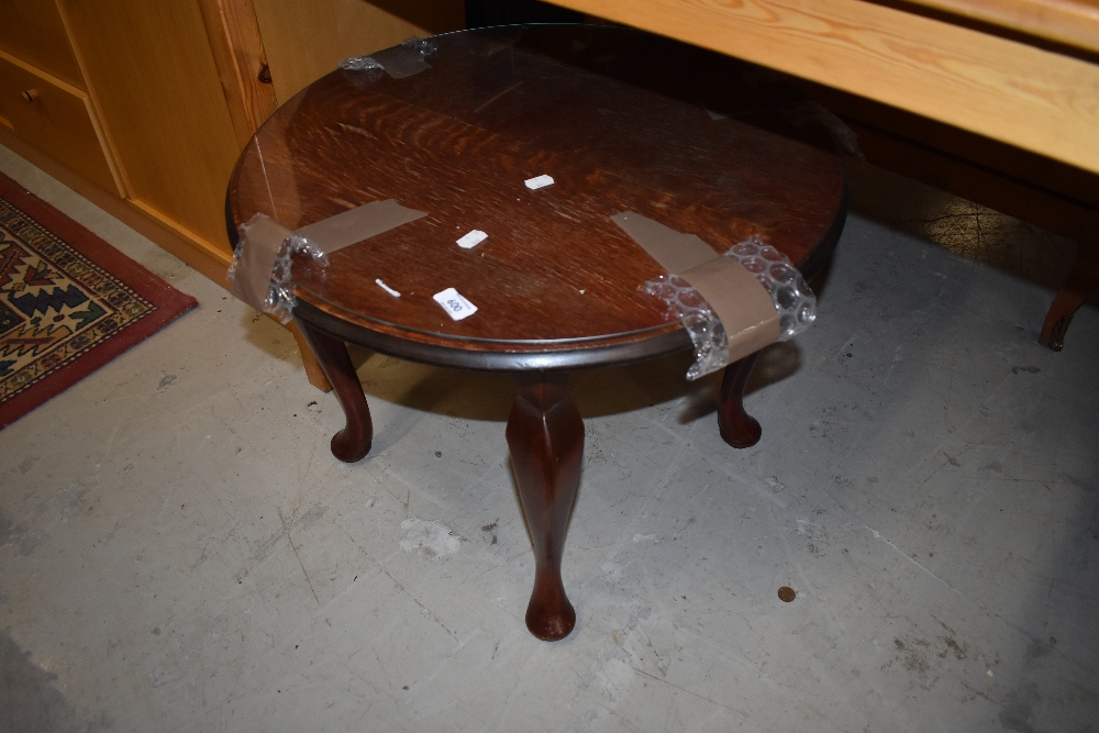 A small circular side or tea table having cabriole legs standing at 46cm high