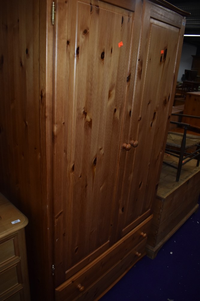 A modern pine wardrobe having double drawer base, width approx. 100cm, height 187cm