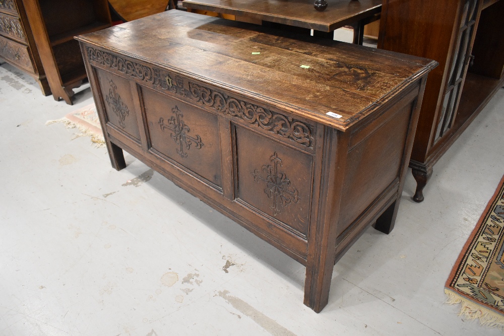 A period oak coffer having plank style top, carved frieze bearing monogram HG and date 1704, and