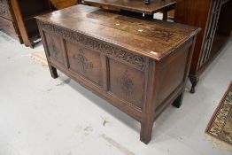 A period oak coffer having plank style top, carved frieze bearing monogram HG and date 1704, and