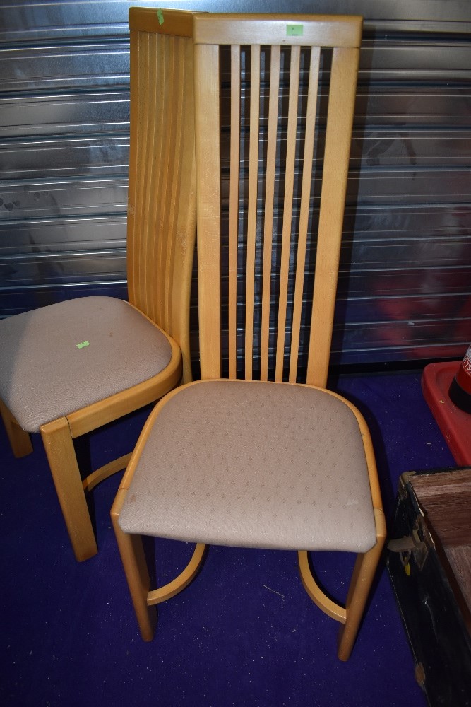 A set of eight modern rail back dining chairs having upholstered seats