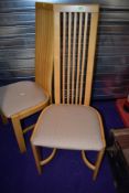 A set of eight modern rail back dining chairs having upholstered seats