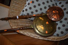 A traditional copper and brass warming pan (worm to handle) and a copper chestnut roaster