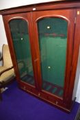 A reproduction mahogany glass fronted display cabinet having green beize lining and fitting for