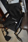 A manual wheel chair, in very clean condition with only light if any use