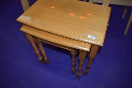 A modern light stained nest of three tables