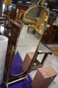 A vintage brass frame cheval mirror in a classical style
