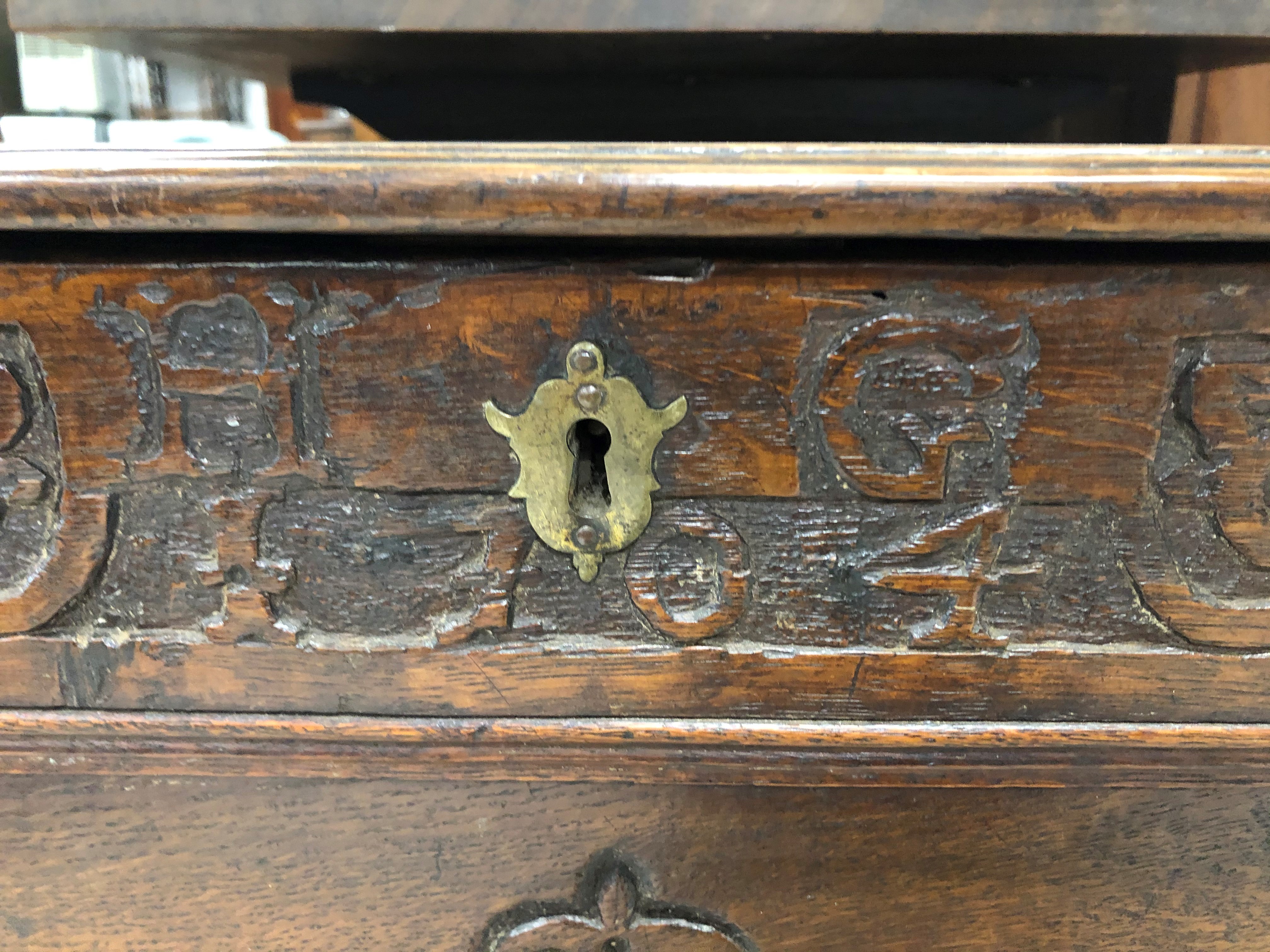 A period oak coffer having plank style top, carved frieze bearing monogram HG and date 1704, and - Image 2 of 2