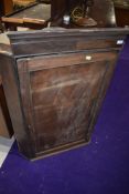 A 19th Century mahogany corner cupboard, in need of restoration , having painted green shelf