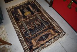 A Persian rug having temple style decoration, approx. 140 x 85cm