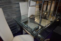 A modern glass extending dining table , having chrome frame and set of six complimenting chrome