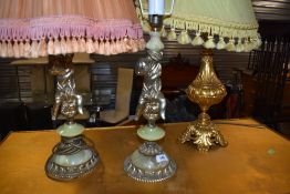A pair of part onyx cherub table lamps and a gilt metal table lamp