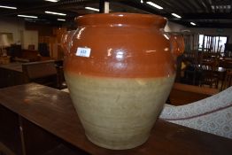 A traditional part glazed stoneware crockpot, with lid