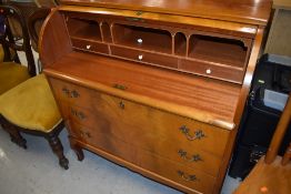 A mid 20th Century sapele and bleached mahogany roll top desk having triple drawer base , width