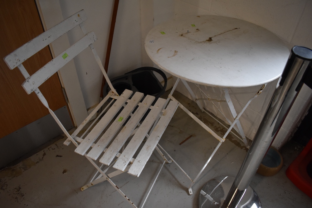 A painted metal folding garden table and similar chair with wood slats, table diameter approx. 60cm