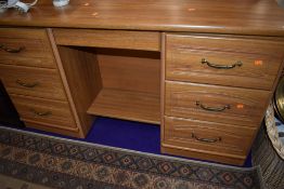 A laminate teak effect dressing table, width approx. 141cm