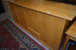 A modern beech effect high sideboard, dimensions approx. W183cm H88cm D48cm (at deepest point)