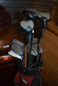 A selection of vintage golf clubs and bag