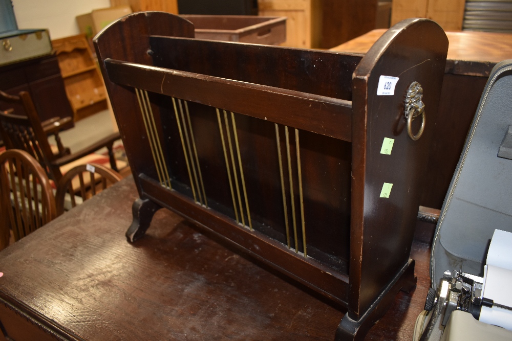 A reproduction Regency mahogany magazine rack having lion mask handles