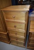 A modern pine bedroom chest of five narrow drawers, nice quality with tongue and groove drawer
