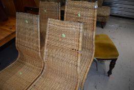 A set of four modern wicker dining chairs