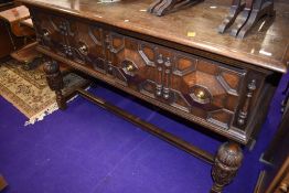 A traditional oak sideboard/dresser base having two cushioned deep drawers, in the Jacobean