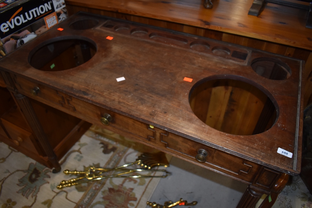 An interesting and unusual Victorian mahogany wash stand , having cut out and recessed sections to