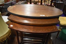 An early 20th Century mahogany nest, top table possibly having had top replaced, two undertables