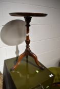 A traditional mahogany occasional/wine table, height approx. 50cm, diameter 30cm