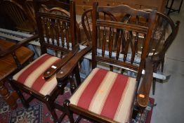 A pair of hard wood framed carver chairs having striped upholstery