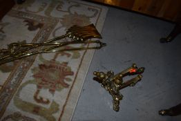 A selection of brass fire tools, including pair firedogs