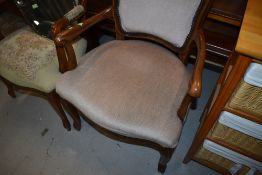 A matched pair of reproduction bedroom arm chairs in the continental style