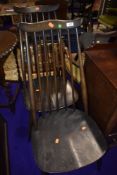 A pair of dark stained Ercol comb and wave back dining chairs