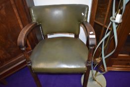 A late 19th or early 20th Century office armchair having green leather seat and back