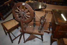 A traditional dark oak spinning wheel