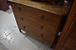 A early to mid 20th Century oak bedroom chest having ledge back , canted top and three long drawers,
