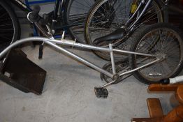 A tag along style towed childs trailer bike