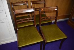 A set of four reproduction Regency rail back dining chairs having inlay to top rails, dralon seats