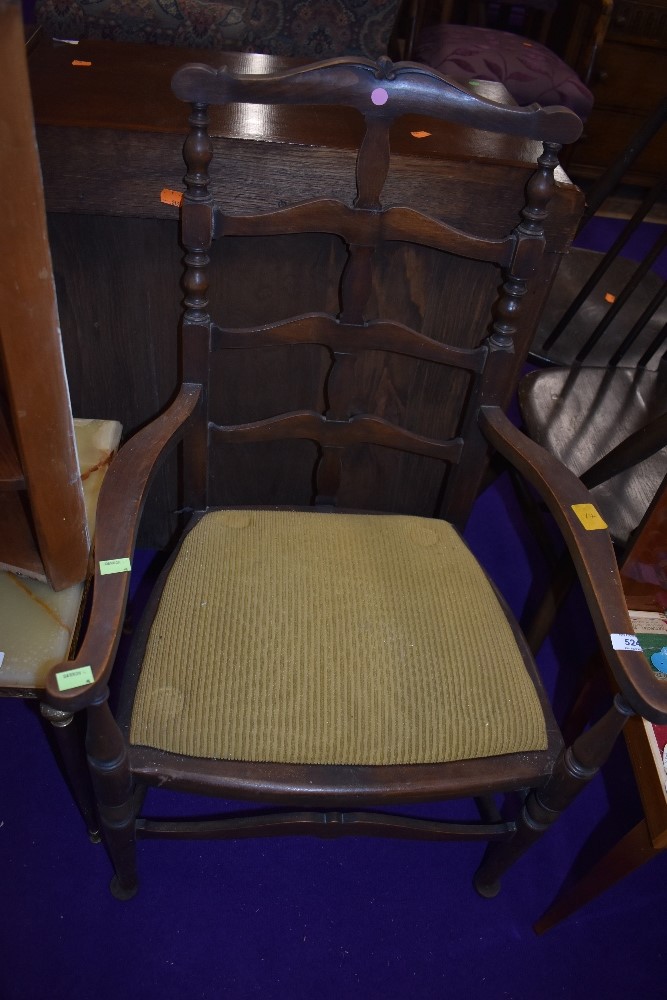 A late 19th or early 20th Century carver chair having turned and shaped frame and drop in