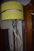 A vintage standard lamp having brass and metal twist frame , later complimentary shade