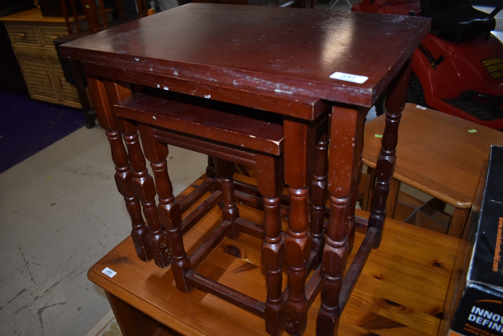 A modern mahogany effect nest of three tables