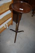 A late 19th/early 20th Century mahogany wine table on turned column and triple splay legs,