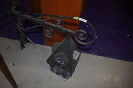 A wrought iron outside light bracket