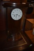 A modern mahogany case clock, named for Hermle in glass case having curved front, with pendulum