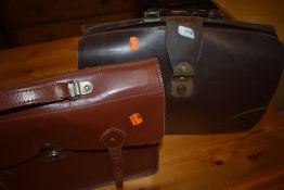 A vintage leather satchel and similar briefcase