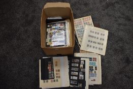 A box of World Stamps, mint & used, on sheets, on hangers, old & modern