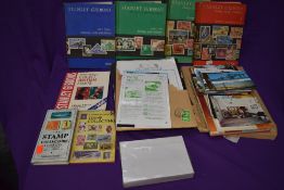 A collection of World Stamps, mint & used, along with Stanley Gibbons Catalogues