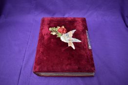 A Victorian photograph album, mainly of Rochdale Families, having bird and rose decoration and